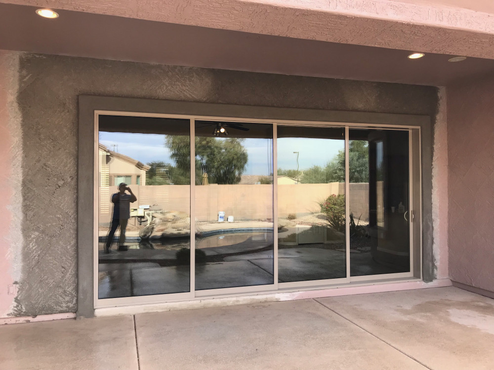 A replacement sliding glass door is being installed in a house.